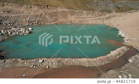 A mountain artificial lake with blue water and dam A mountain artificial lake with blue water and dam 94821719