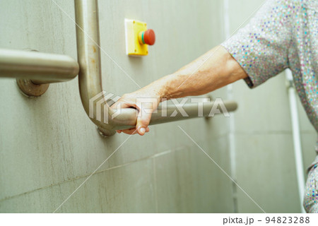 Asian elderly old woman patient use toilet support rail in bathroom, handrail safety grab bar, security in nursing hospital. Asian elderly old woman patient use toilet support rail in bathroom, handrail safety grab bar, security in nursing hospital. 94823288