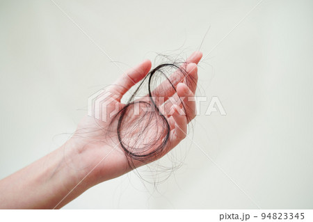 Asian woman have problem with long hair loss attach in her hand. Asian woman have problem with long hair loss attach in her hand. 94823345