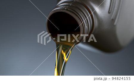 Pouring Oil from Plastic Container, Macro Shot Pouring Oil from Plastic Container, Macro Shot 94824155