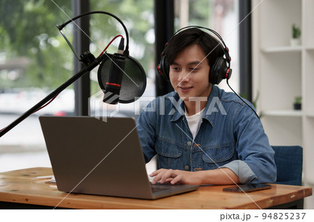Podcaster editing audio podcast working at home studio Podcaster editing audio podcast working at home studio 94825237