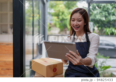 Asian SME business woman working at home office. online shopping concept Asian SME business woman working at home office. online shopping concept 94825433