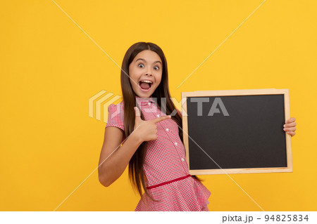 amazed kid hold school blackboard for copy space showing thumb up, announcement amazed kid hold school blackboard for copy space showing thumb up, announcement 94825834