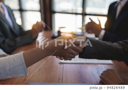 Business team and lawyer shaking hand after discussing about agreement contract. Law, legal services, advice, Justice concept Business team and lawyer shaking hand after discussing about agreement contract. Law, legal services, advice, Justice concept 94826489