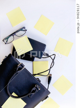 Composition with black bag, external hard disks, colorful paper Composition with black bag, external hard disks, colorful paper 94828117