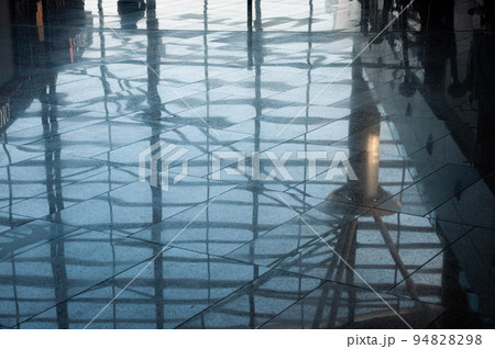 View of the reflections on the airport floor by the windows. 94828298