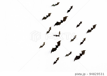 halloween and decoration concept - black 3d paper bats flying over white background. halloween and decoration concept - black 3d paper bats flying over white background. 94829531
