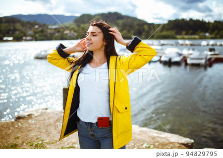 Young woman enjoys freedom against the backdrop of the mountains in the Norway. The girl tourist. Young woman enjoys freedom against the backdrop of the mountains in the Norway. The girl tourist. 94829795