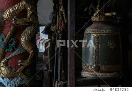 Sculptured golden dragons red pillar and Traditional old green iron bell hanging in Phutthamonthon sathan. Sculptured golden dragons red pillar and Traditional old green iron bell hanging in Phutthamonthon sathan. 94837256