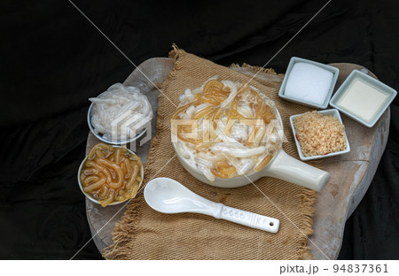 Kanom pla krim khai tao or Sweet rice noodles with coconut cream in white ceramic bowl. Kanom pla krim khai tao or Sweet rice noodles with coconut cream in white ceramic bowl. 94837361