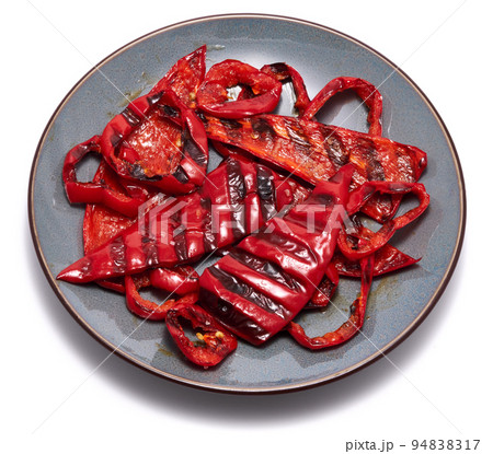 Grilled Slices of red pepper with stripes from a grill in ceramic plate isolated on white background Grilled Slices of red pepper with stripes from a grill in ceramic plate isolated on white background 94838317