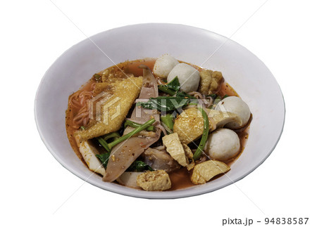 Traditional yentafo thin rice stick noodles with pink sauce and fish balls, shrimp ball, crisp squid pickled, chinese morning glory and fried wonton in white bowl. Traditional yentafo thin rice stick noodles with pink sauce and fish balls, shrimp ball, crisp squid pickled, chinese morning glory and fried wonton in white bowl. 94838587