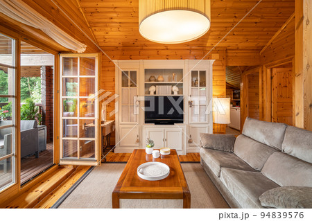 Cozy interior of a country house in a wooden design. Spacious living room on the second floor 94839576