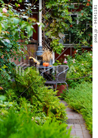 A path in the country house's garden. landscape design of the yard. A path in the country house's garden. landscape design of the yard. 94841181