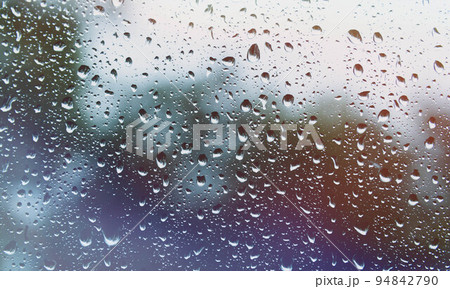 Sun after rain. Drops on glass. It's been raining. Texture on glass. 94842790