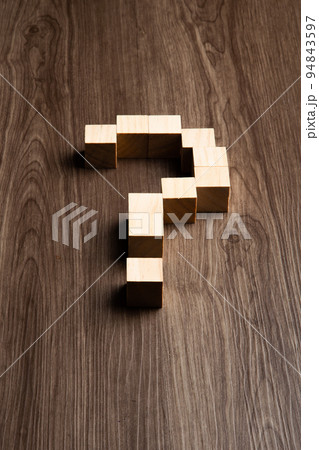 Forming bigger question mark. question mark on wooden table background 94843597