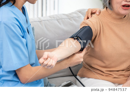 An elderly woman with a contented life having a blood pressure check. An elderly woman with a contented life having a blood pressure check. 94847537