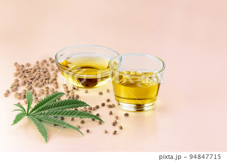Legalized marijuana concept CBD oil in glass bowl and bottle with dropper lid. Legalized marijuana concept CBD oil in glass bowl and bottle with dropper lid. 94847715