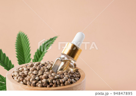 Hemp seeds with green sativa hemp leaf on top. Legalized marijuana concept. 94847895
