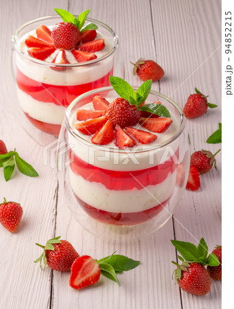 creamy dessert with strawberries in a glass bowl 94852215