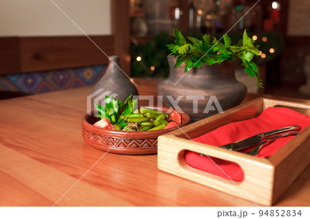 Georgian green bean dish on a table of a restaurant. Dish of Georgian cuisine.. Georgian green bean dish on a table of a restaurant. Dish of Georgian cuisine.. 94852834