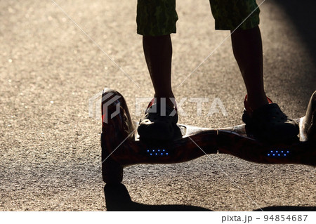 silhouette riding on a segway 94854687