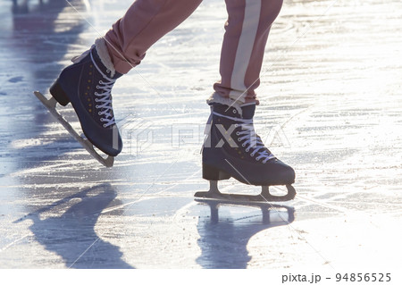 girl ice skating on an ice rink. hobbies and leisure. winter sports 94856525
