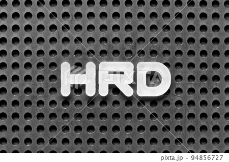 White alphabet letter in word HRD (Abbreviation of human resource development) on black pegboard background 94856727