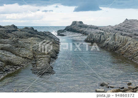 coastal seascape with beautiful columnar basalt rocks at low tide 94860372