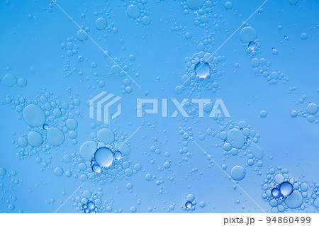 Oil and water bubbles on blue background. Abstract face cleanser bubbles background. 94860499
