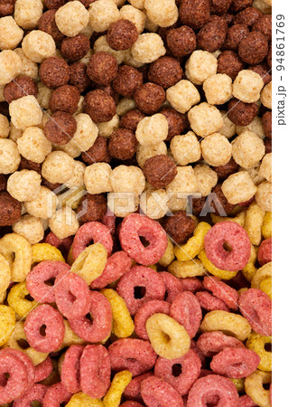 A set of different quick breakfast cereals - rings and balls, top view on white. A set of different quick breakfast cereals - rings and balls, top view on white. 94861769