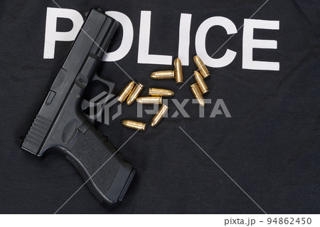 Police black uniform and hahdgun with cartidges background Police black uniform and hahdgun with cartidges background 94862450