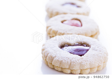 Linzer Torte cookies on white background with powdered sugar sprinkled on top. Linzer Torte cookies on white background with powdered sugar sprinkled on top. 94862750