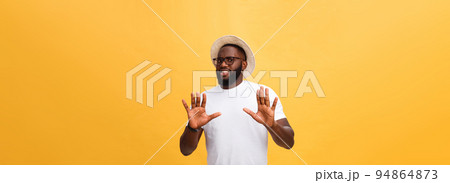 Portrait shock and annoyed displeased young man raising hands up to say no stop right there isolated orange background. Negative human emotion, facial expression, sign, symbol, body language 94864873