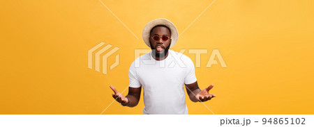 Young african american man wearing white t-shirt shouting and screaming loud to side with hand on mouth. Communication concept. 94865102