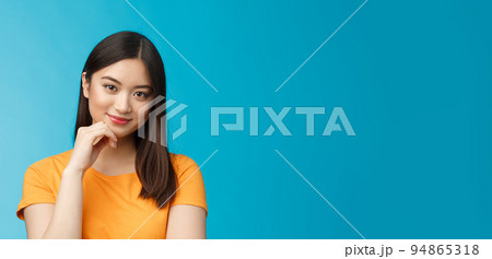 Close-up coquettish good-looking asian young modern woman curiously listen interesting story, smirking relaxed gaze camera, touch chin thoughtful, intrigued stand blue background Close-up coquettish good-looking asian young modern woman curiously listen interesting story, smirking relaxed gaze camera, touch chin thoughtful, intrigued stand blue background 94865318