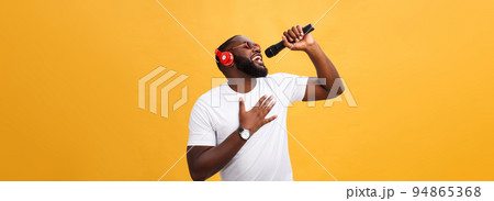 young handsome african american boy singing emotional with micro 94865368