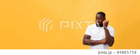 Young Stressed man with hand on his face showing sadness and despair. Isolated over yellow background. 94865758