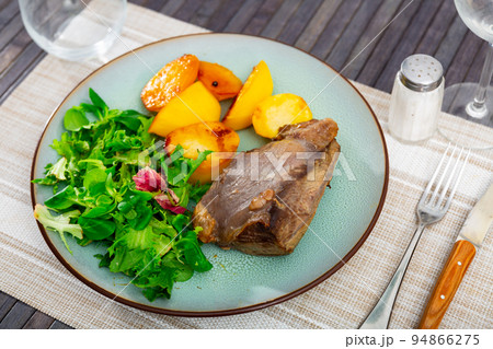 Appetizing grilled beef meat with potato and salad with arugula Appetizing grilled beef meat with potato and salad with arugula 94866275