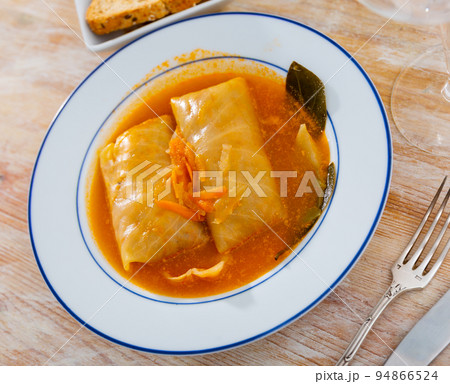 Cabbage rolls in cabbage leaves with sour cream, dish of Eastern European cuisine closeup Cabbage rolls in cabbage leaves with sour cream, dish of Eastern European cuisine closeup 94866524