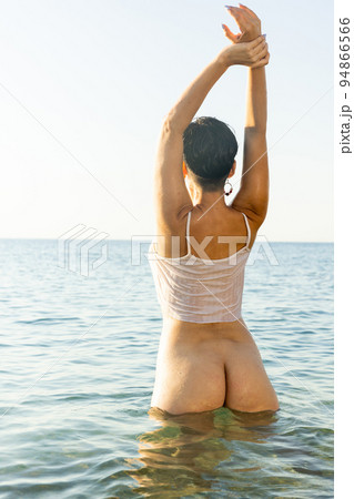 Tempting half-naked brunette posing in shallow water 94866566