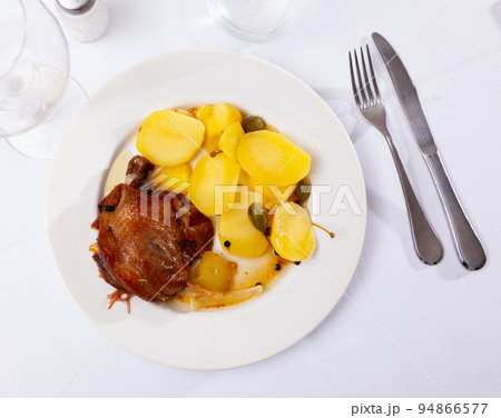 Portion of duck confit on table 94866577