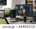 Designer's computer on table with a 3D model of a dog robot on a monitor screen 94869316