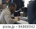 African American artist draws on tablet 3D model for computer game 94869342
