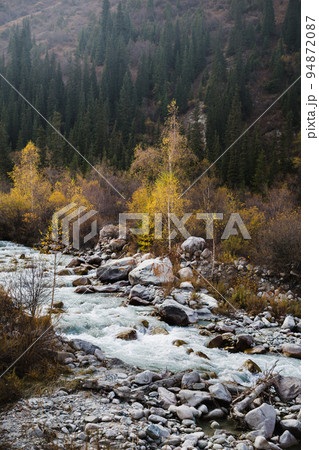 Glacial river flows through the Ala Archa mountain pass Glacial river flows through the Ala Archa mountain pass 94872087