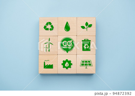 Net Zero and Carbon Neutral Concepts, Net Zero Emissions Goals, Long-Term Climate Neutral Strategies. wooden cube with green net center icon and green icon related to global environment. Net Zero and Carbon Neutral Concepts, Net Zero Emissions Goals, Long-Term Climate Neutral Strategies. wooden cube with green net center icon and green icon related to global environment. 94872392