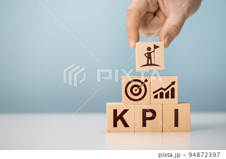 KPI - Key Performance Indicator. Businessman holds cube with KPI, KPI key performance indicator increase optimisation business. Business planning and measure success, target achievement. 94872397