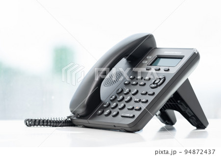 telephone devices at white office desk with light effect, communication technology concept. VOIP or IP phone. Modern Phone VoIP. Communication support, call center and customer service help desk telephone devices at white office desk with light effect, communication technology concept. VOIP or IP phone. Modern Phone VoIP. Communication support, call center and customer service help desk 94872437