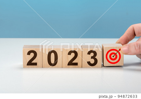 2023 goal. hand putting wooden cubes 2023 with goal icon on table and blue background, copy space. Start new year 2023 with goal plan. Starting to new year. Goals, plan, strategy, business, idea 94872633