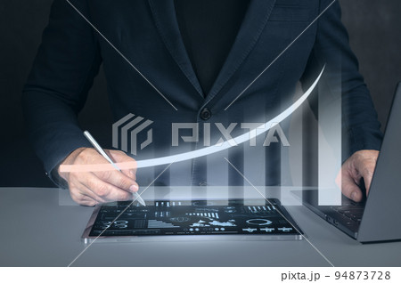 Businessman using tablet analyzing sales data and economic growth graph chart. Business strategy, financial and banking. Digital marketing. Businessman using tablet analyzing sales data and economic growth graph chart. Business strategy, financial and banking. Digital marketing. 94873728